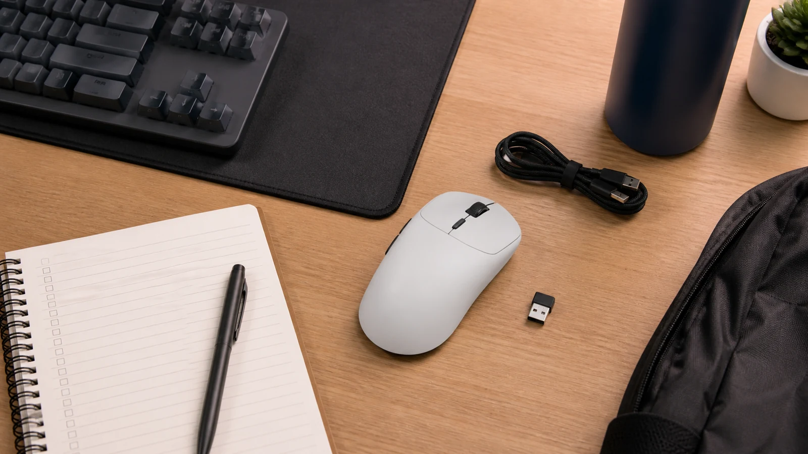 University LAN travel kit with wireless gaming mouse, USB receiver and USB-C cable on a UK student desk